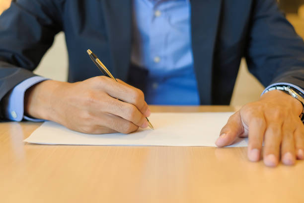 istock Businessman hands writing or signing on document paper. Insurance and Interview concept 1150979225