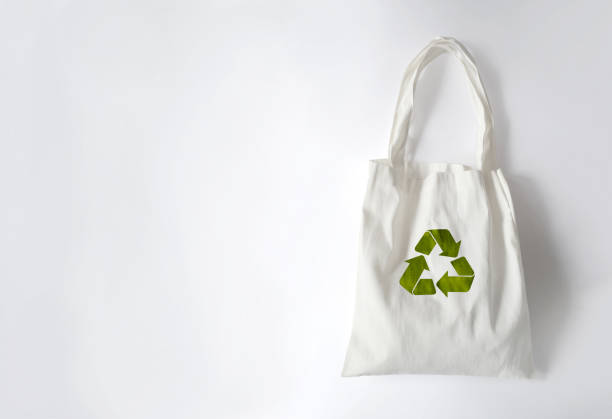 White cloth bag with recycled symbol, isolated on a white background stock photo