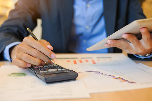 istock Businessman using tablet for analysis maketing plan, Accountant calculate financial report, computer with graph chart.  Business, Finance and Technology concepts 1150979526