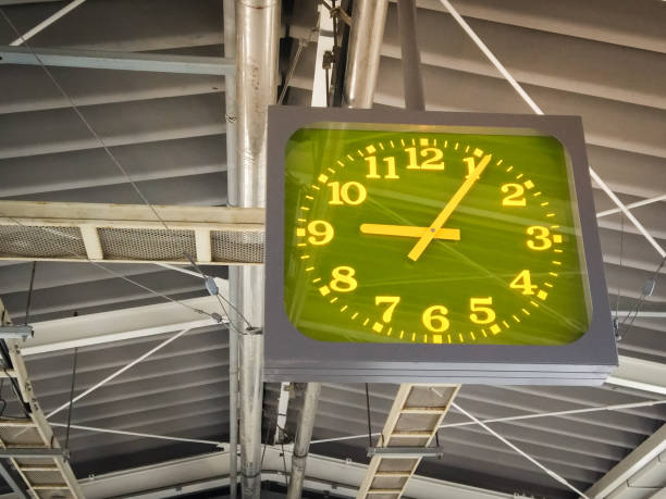 Green highlight clock hang on the roof at train station in japan. Close up of clock