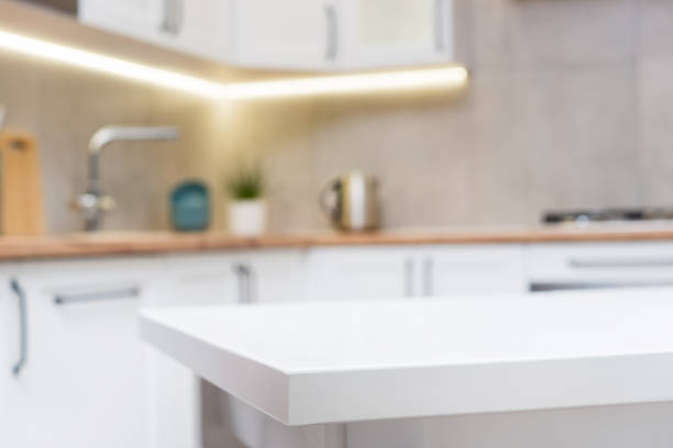 istock Focus on a white wooden table and scandinavian kitchen 1150979841