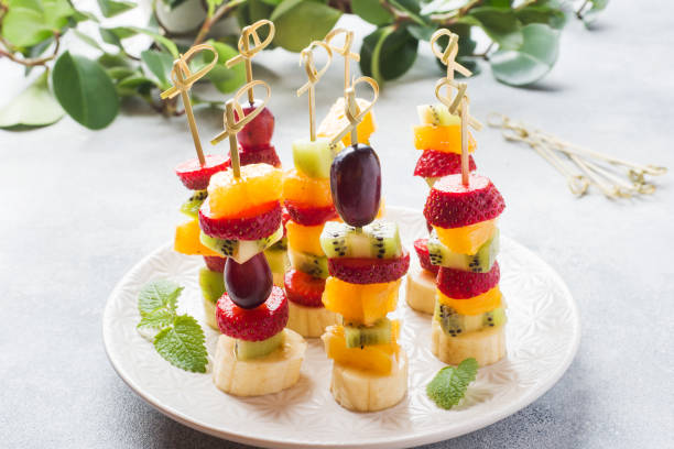 istock Fresh fruit on skewers. Concept buffet for a summer party. 1150980474