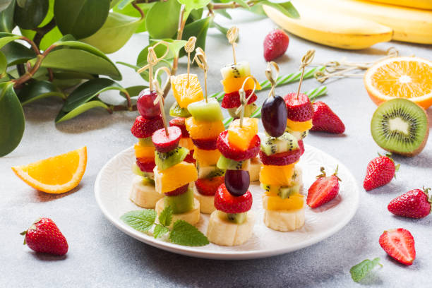 istock Fresh fruit on skewers. Concept buffet for a summer party. 1150980524
