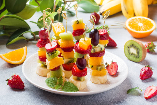 istock Fresh fruit on skewers. Concept buffet for a summer party. 1150981111