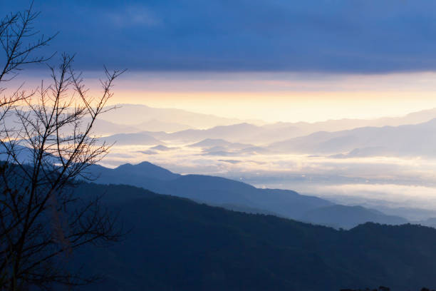 istock Dramatic blue clouds and morning mist covered a blue mountain range. 1150981305