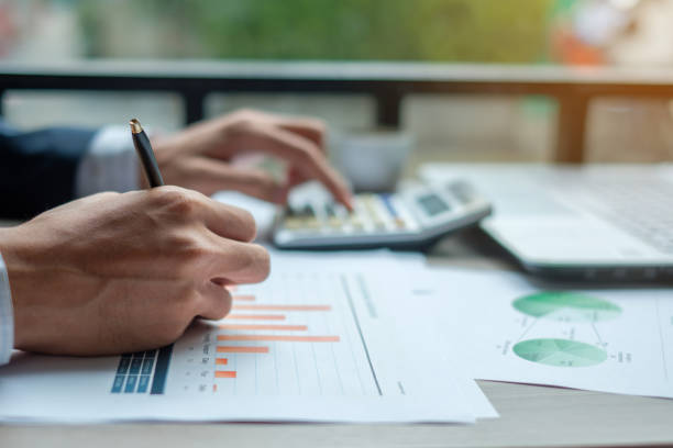 istock Businessman analysis maketing plan, Accountant calculate financial report, computer with graph chart.  Business, Finance and Accounting concepts 1150981368