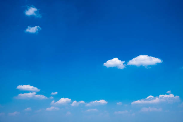 istock Beautiful clear blue sky with white fluffy clouds on a sunny day. 1150985368
