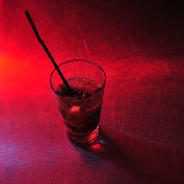istock Cup of drink with a red and purple light 1150987862