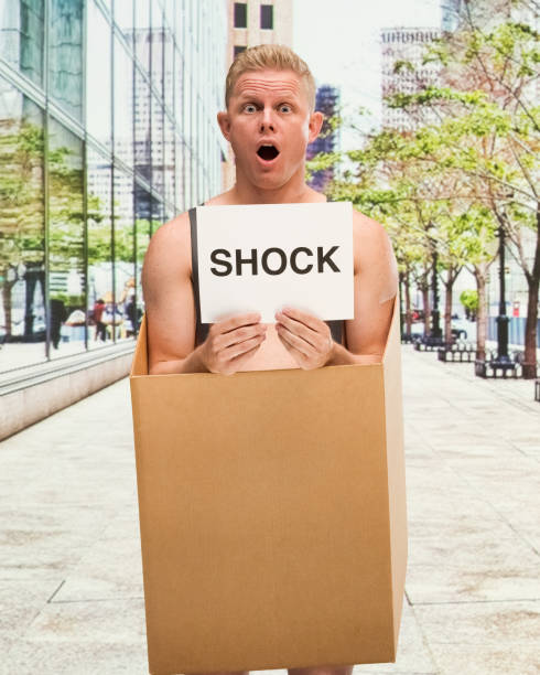 istock Poverty man in box shirtless is shocked 1150994536