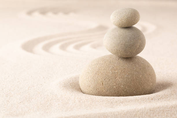 istock Yoga or spa wellness sandy background with round zen stone 1150995403