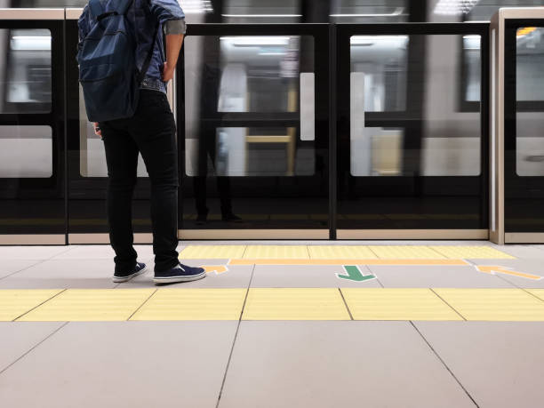 istock Young man waiting on the subway station while metro wagon passing 1150995659
