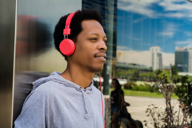 istock Young man enjoying music outdoor. 1150997442