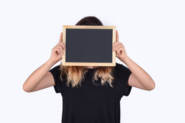 istock Woman holding chalkboard. 1150997691