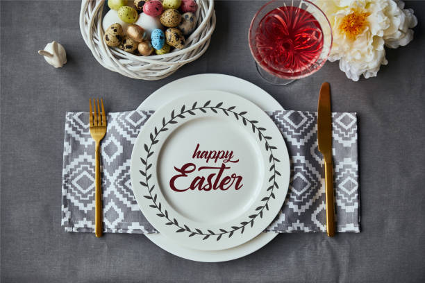 istock top view of festive table setting for Easter with decor and happy Easter lettering on plate 1150998653