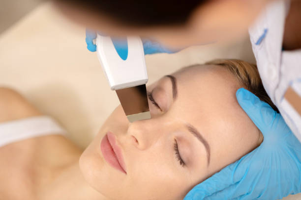 istock Young woman closing eyes while having deep facial cleansing 1150999219