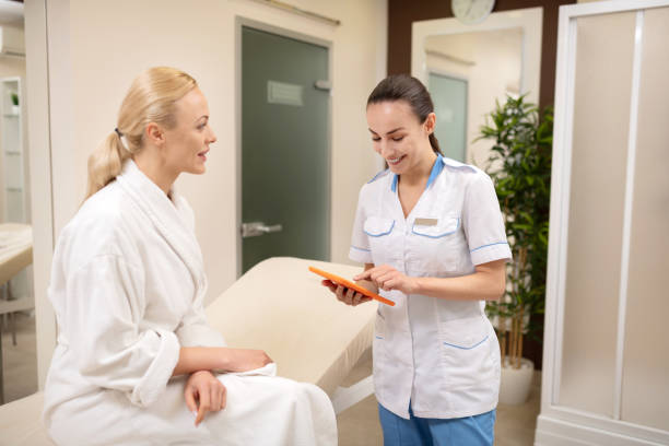 istock Female cosmetologist discussing future appointment with client 1150999234