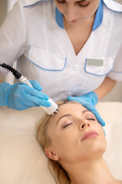 istock Cosmetologist doing ultrasound skin tightening for client 1150999250