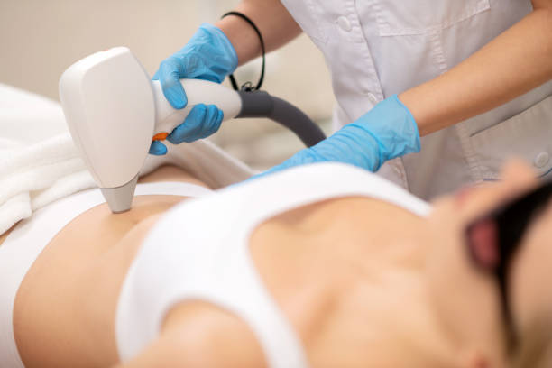 istock Depilatory specialist in uniform using equipment for laser depilation 1151000494