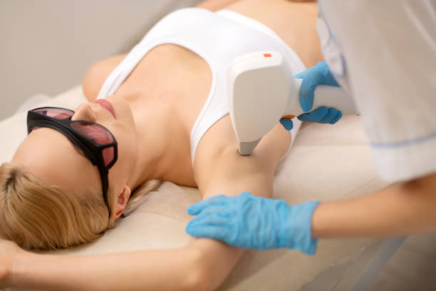 istock Blonde client having laser depilation under arms 1151000516