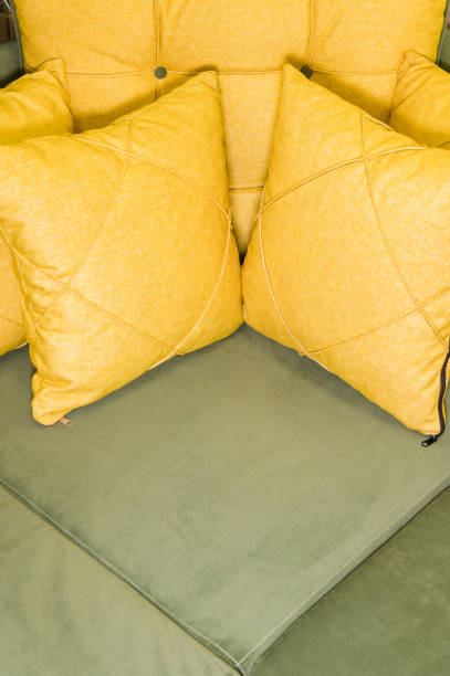 istock Close-up green corner sofa with yellow pillows 1151003713