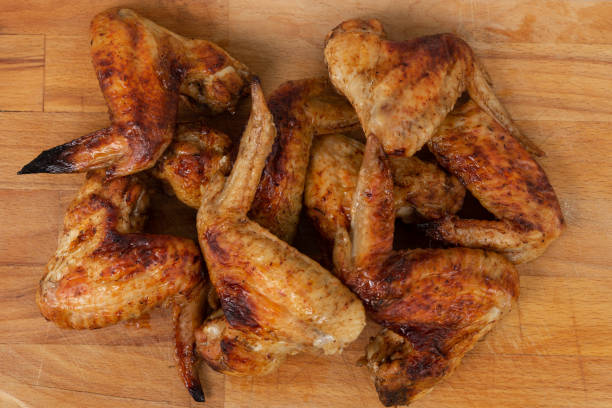 istock Baked chicken wings served on the wooden table 1151004414