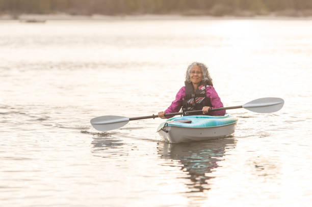 istock Senior woman kayaking on the river 1151006382
