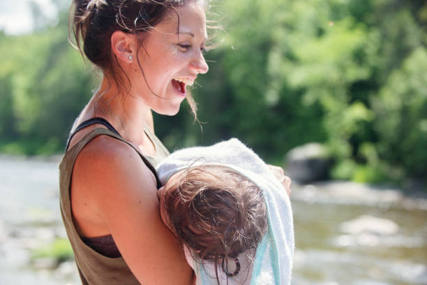 istock Mom holding her daughter during summer day 1151006496