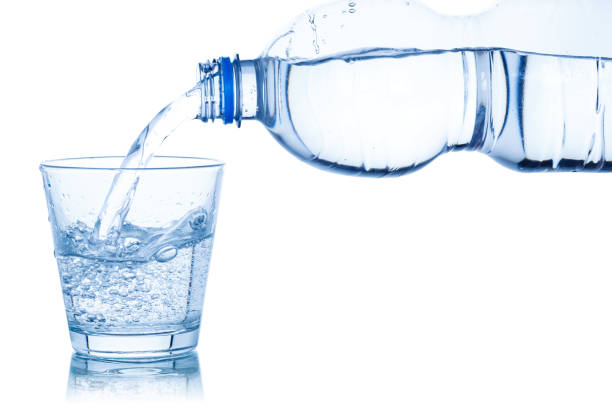 istock Water pouring into glass isolated on white 1151006767