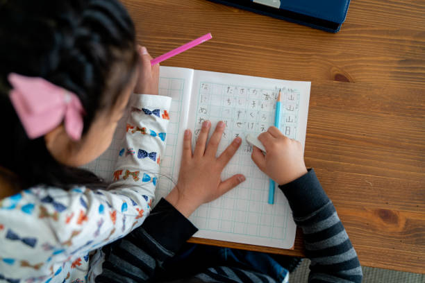 istock Aerial view of a young boy erasing an error in his homework 1151006788