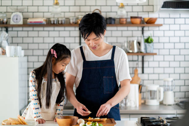 Young father and daughter cooking together at home Young father and daughter cooking together at home. Tokyo Japan child japanese culture japan asian ethnicity stock pictures, royalty-free photos & images