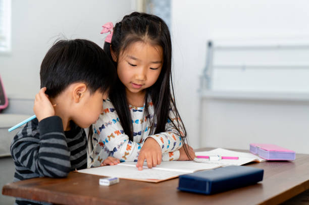 istock Young girl helping her brother with his homework 1151006839