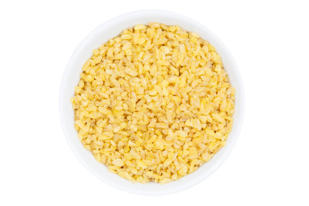istock Bulgur wheat grain grains from above bowl isolated on white 1151006867
