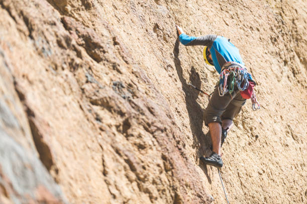 istock Young man climbing a rock face in Oregon 1151007089