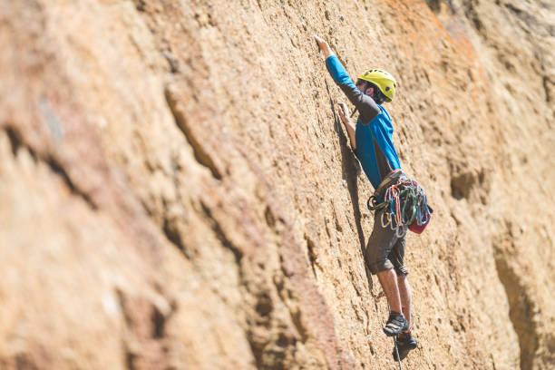 istock Young man climbing a rock face in Oregon 1151007109