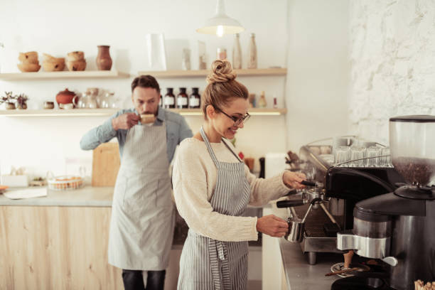 istock Two smiling people by the coffee machine. 1151012623