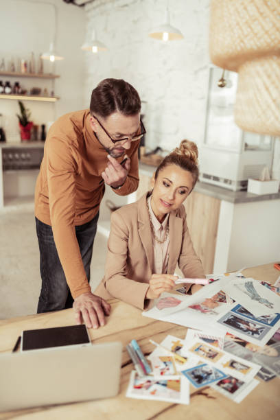 istock Fashion designer and his assistant creating new clothes. 1151012733