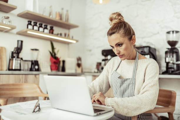 istock Focused cafe owner working at her laptop. 1151012848