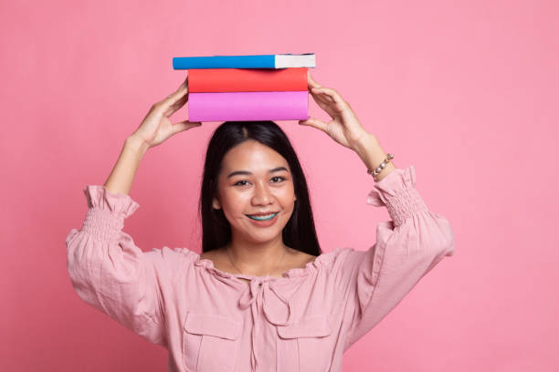 istock Young Asian woman studying  with may books. 1151013306