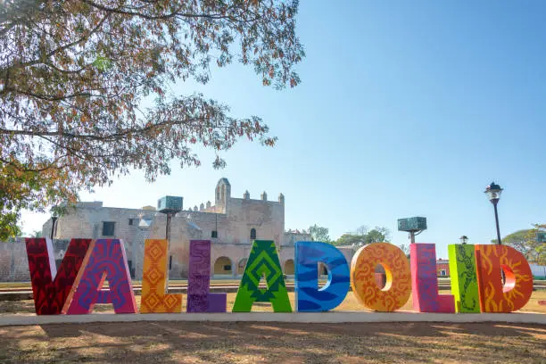 Sign for Valladolid, Mexico with the Convent of San Bernardino in the background