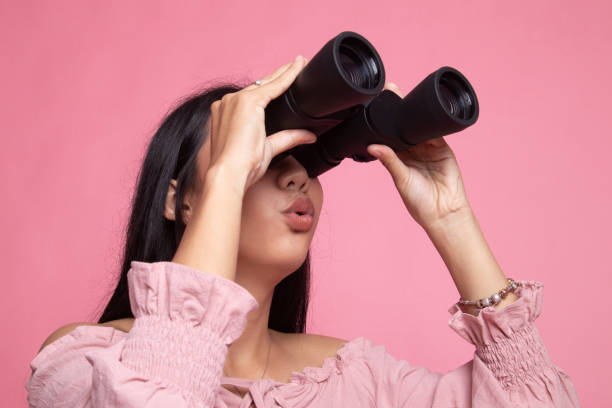 istock Young Asian woman with binoculars. 1151014345