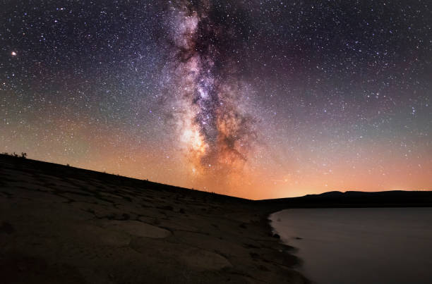 istock Beautiful milky way galaxy over the lake. 1151014431