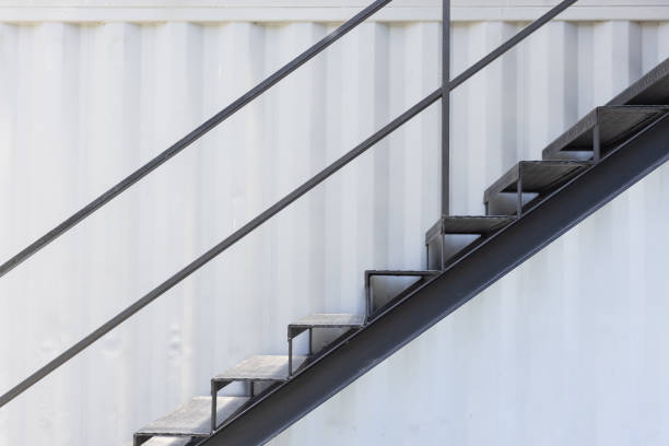 istock outside metal staircase or fire exit stair with sheet corrugated wall background. 1151016652