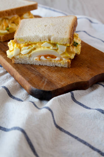 istock Homemade egg salad sandwich on a rustic wooden board, side view. Close-up. 1151016809