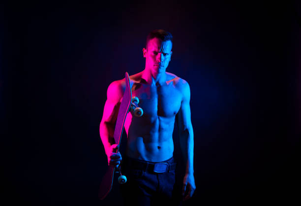 istock Shirtless mascular man holding a skateboard 1151018535