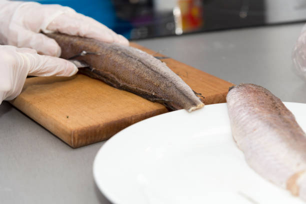 istock Closeup of cook who prepares fish. 1151018791