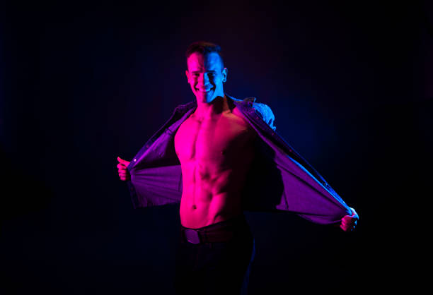 istock Good looking mascular man weraing an unbuttoned blue shirt and feeling sexy 1151018821