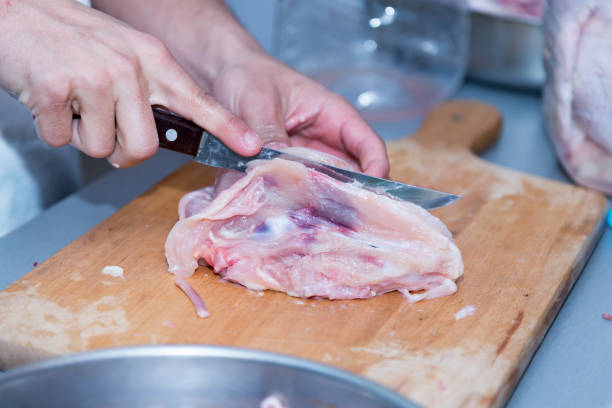 istock A chef prepares raw chicken for cooking. 1151018847