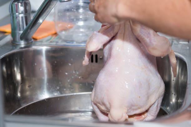 istock A chef prepares raw chicken for cooking. 1151018868