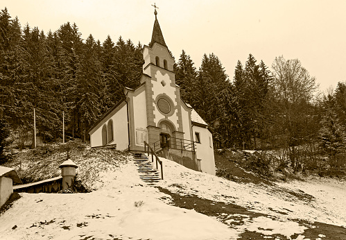 Little chapel in the forest on the mountainside.