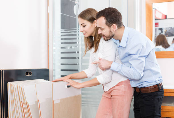 istock Couple choosing ceramic tiles in shop 1151021518